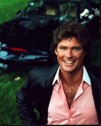 David Hasselhoff wearing a pink shirt in front of a car from Knight Rider - iconic photo print.