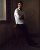 James Wolk Leaning On Stool Photo Print capturing the actor's charisma.