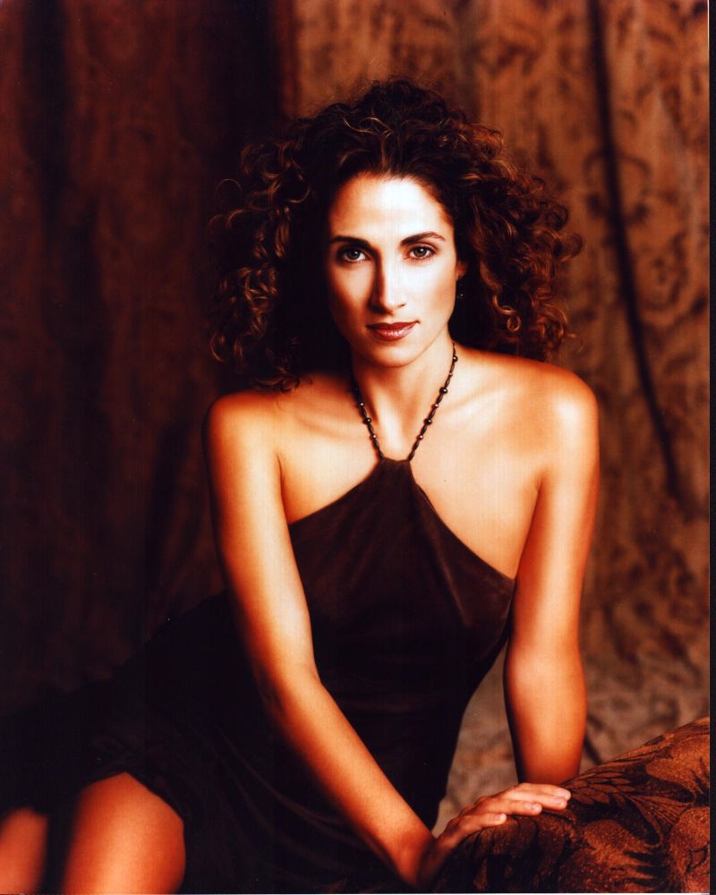 Melina Kanakaredes in a brown halter dress photo print.
