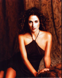 Melina Kanakaredes in a brown halter dress photo print.
