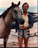 Richard Chamberlain on the beach with a horse photo print