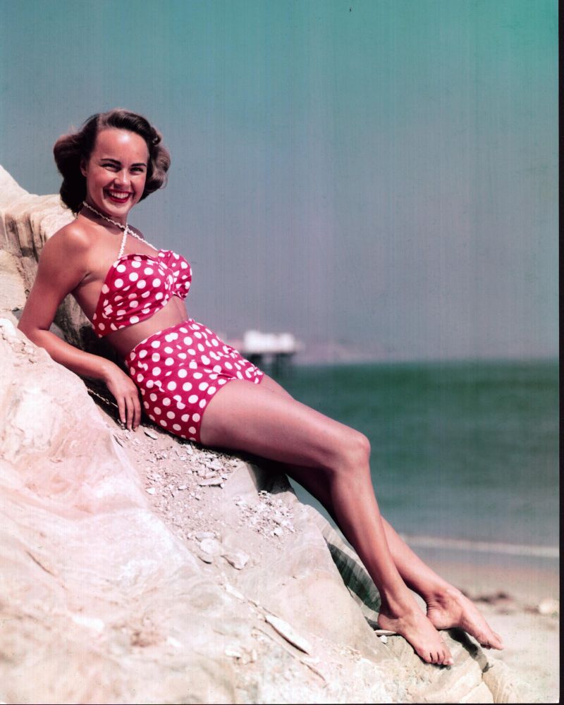 Terry Moore photo print in polka dot bathing suit on rocks.