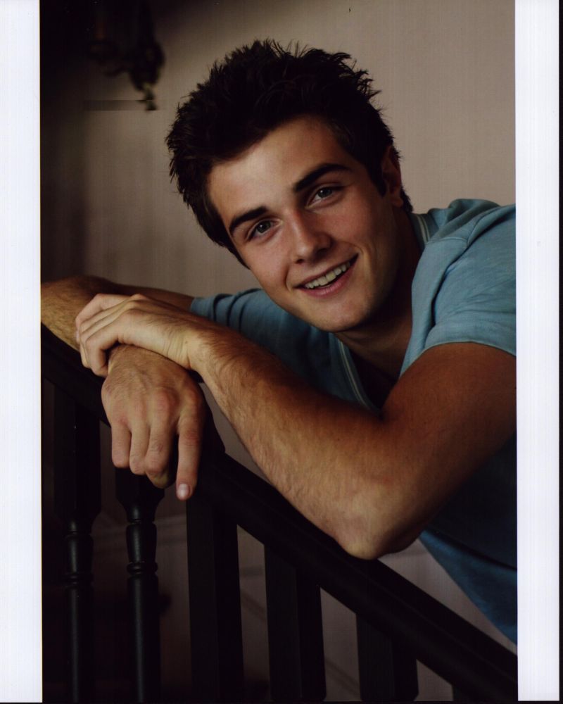 Beau Mirchoff Leaning On Railing Photo Print showcasing vibrant colors.