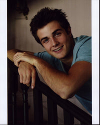 Beau Mirchoff Leaning On Railing Photo Print showcasing vibrant colors.