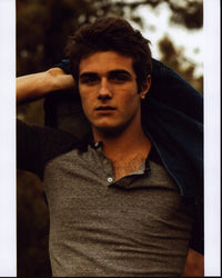 Beau Mirchoff Putting On Jacket Photo Print showcasing the actor's charm
