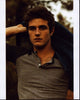 Beau Mirchoff Putting On Jacket Photo Print showcasing the actor's charm