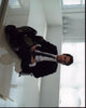 Matt Bomer stylish photo print with feet on table, capturing casual elegance.