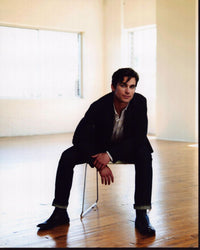 Matt Bomer leaning forward in chair photo print.
