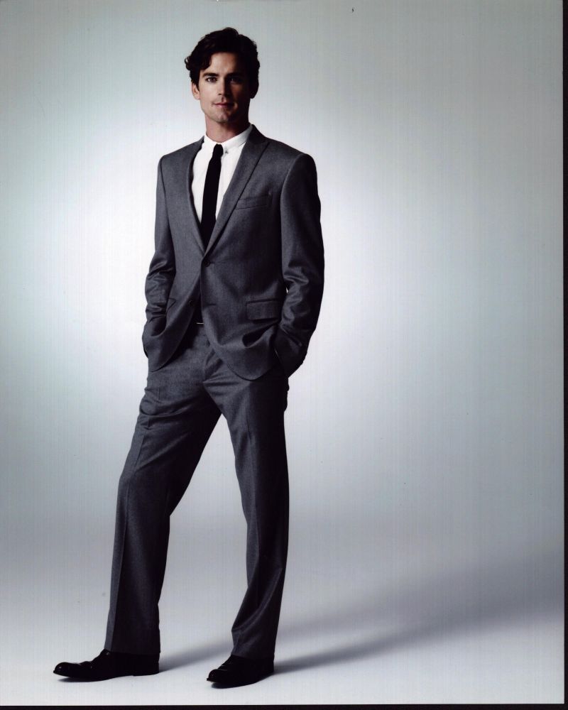 Matt Bomer photo print in gray suit with hands in pockets.
