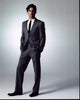 Matt Bomer photo print in gray suit with hands in pockets.