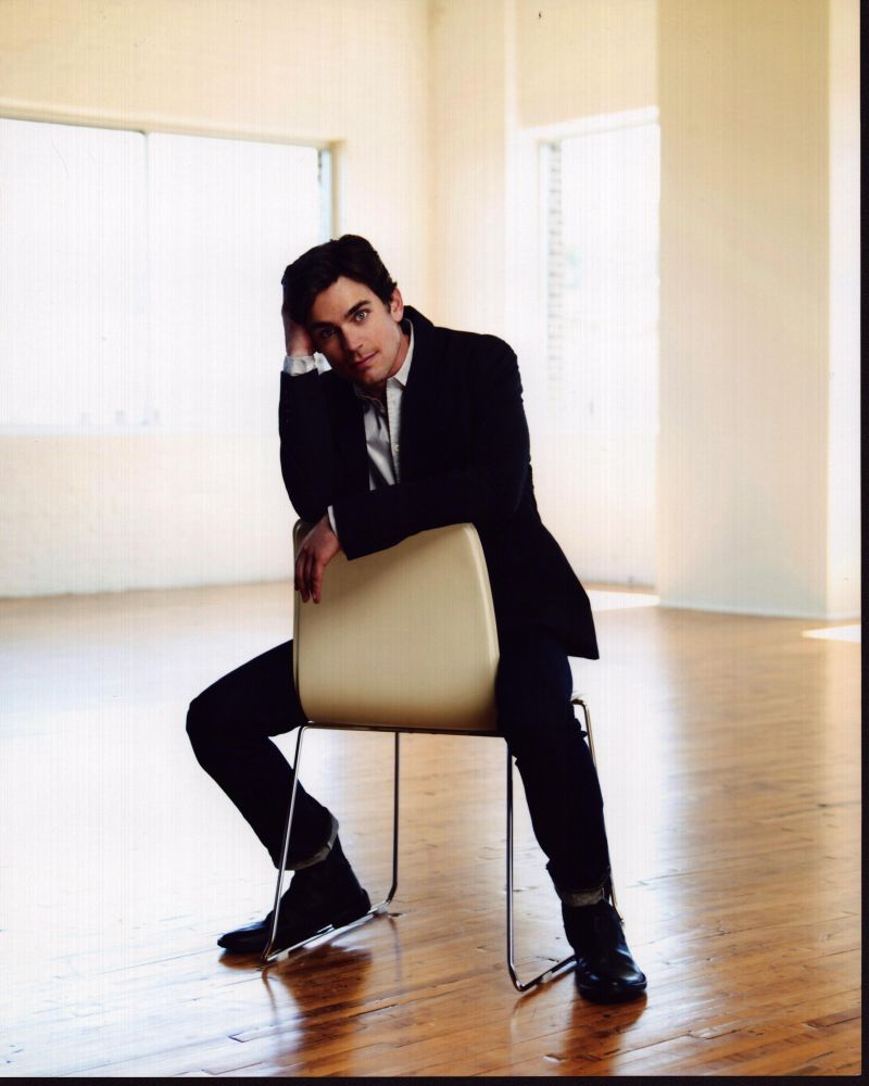 Matt Bomer sitting backwards on a chair photo print