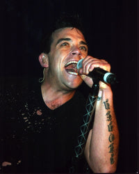 Robbie Williams singing on stage photo print showcasing live performance energy.