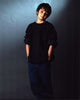 Cj Adams photo print in sweatshirt with hands in pockets.