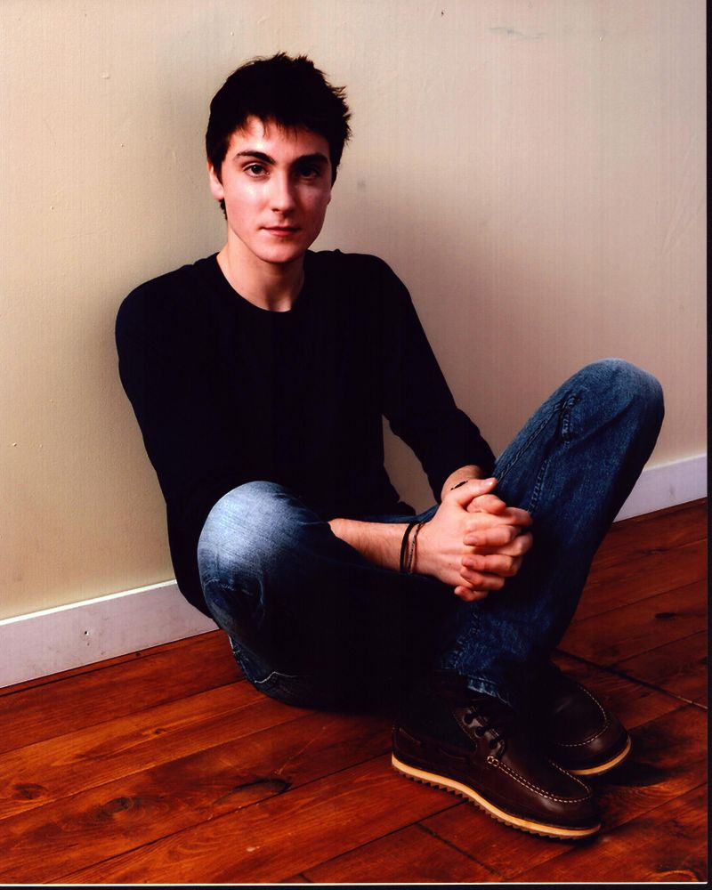 Noah Silver Sitting On Floor Photo Print showcasing serene contemplation.