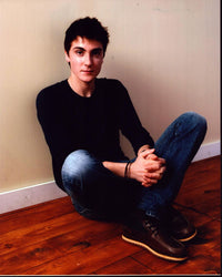 Noah Silver Sitting On Floor Photo Print showcasing serene contemplation.