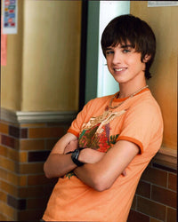David Lambert photo print in orange shirt leaning against wall