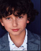 August Maturo photo print in striped shirt and gray blazer.