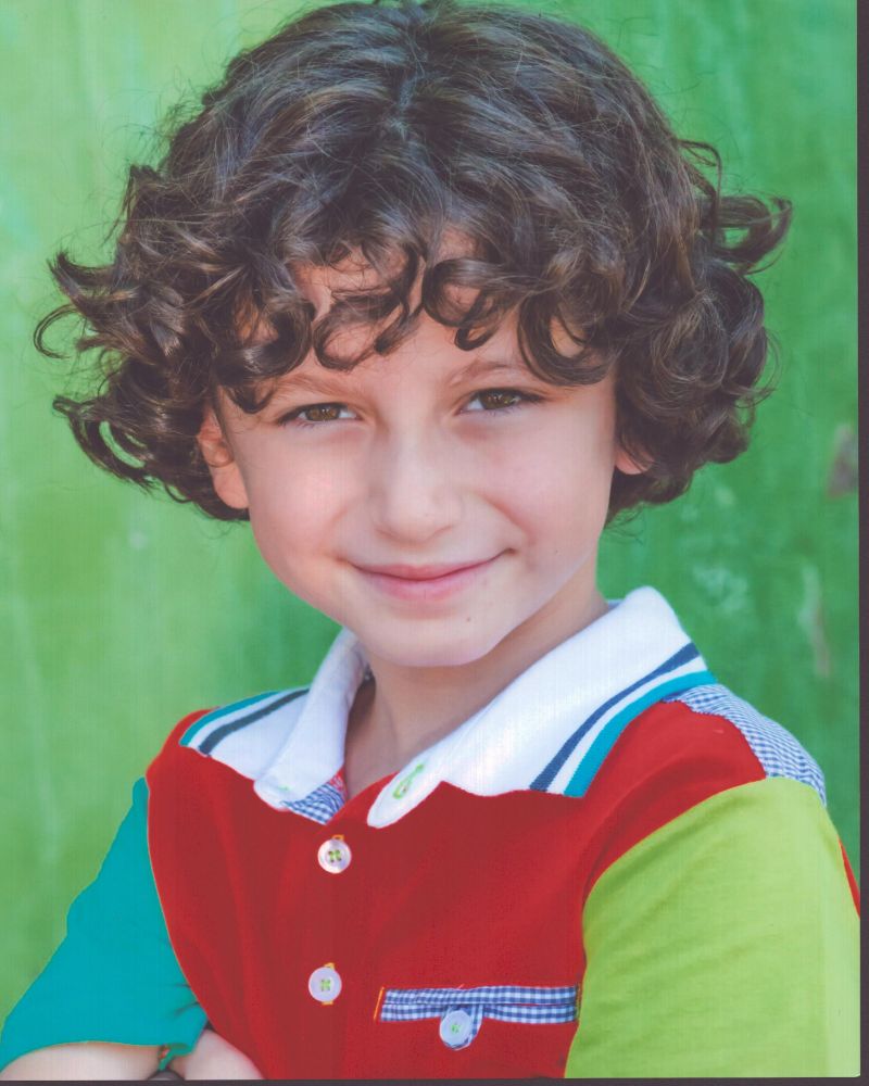 August Maturo headshot photo print in multi-colored shirt.