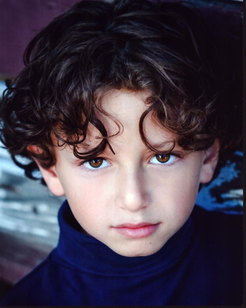 August Maturo headshot photo print in blue turtleneck.
