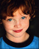 Kyle Red Silverstein headshot photo print in blue and black shirt.
