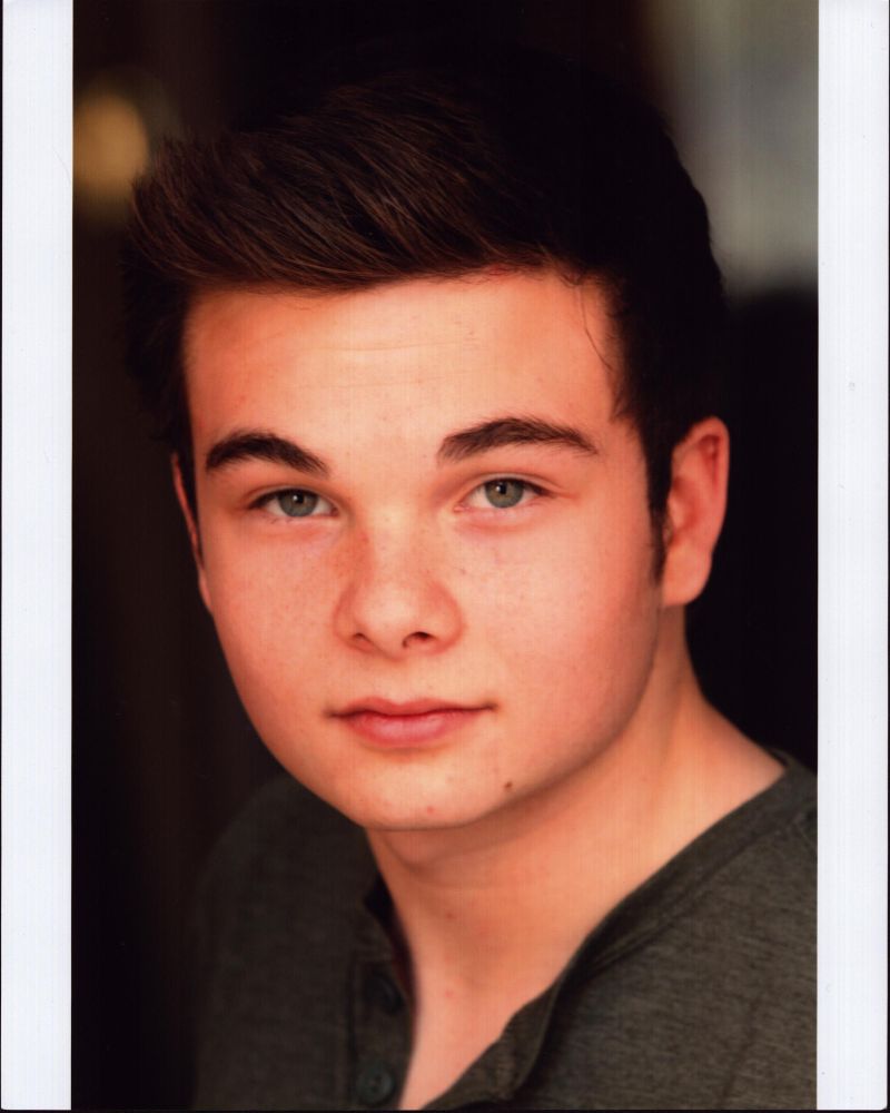 Noah Matthews headshot photo print featuring a vibrant green top.