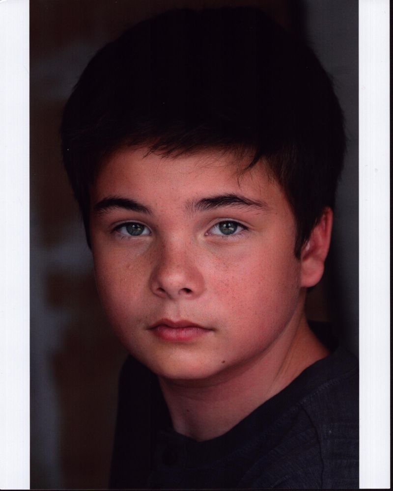 Noah Matthews headshot photo print in gray top