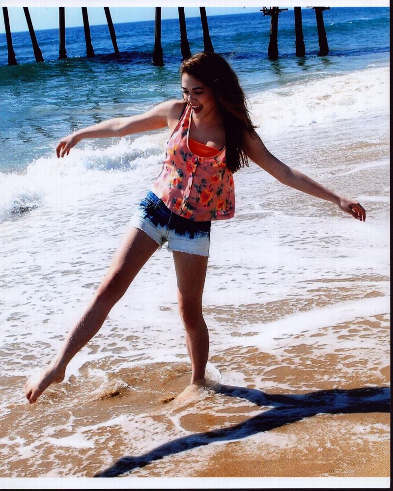 Mckaley Miller Playing In Waves Photo Print showcasing a playful moment by the waves.