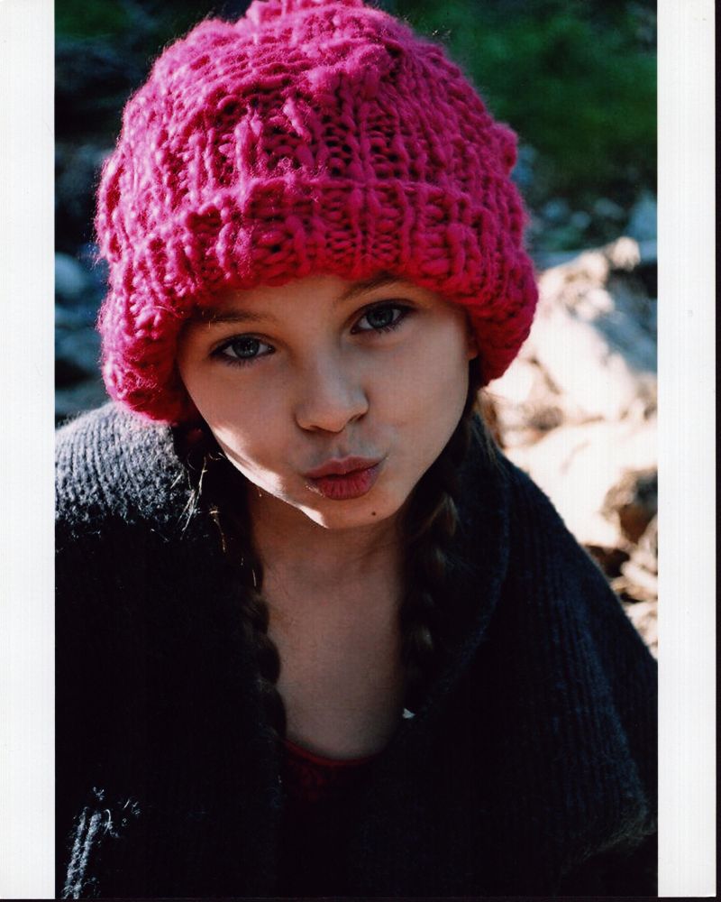 Caitlin Carmichael photo print wearing a pink knit hat.