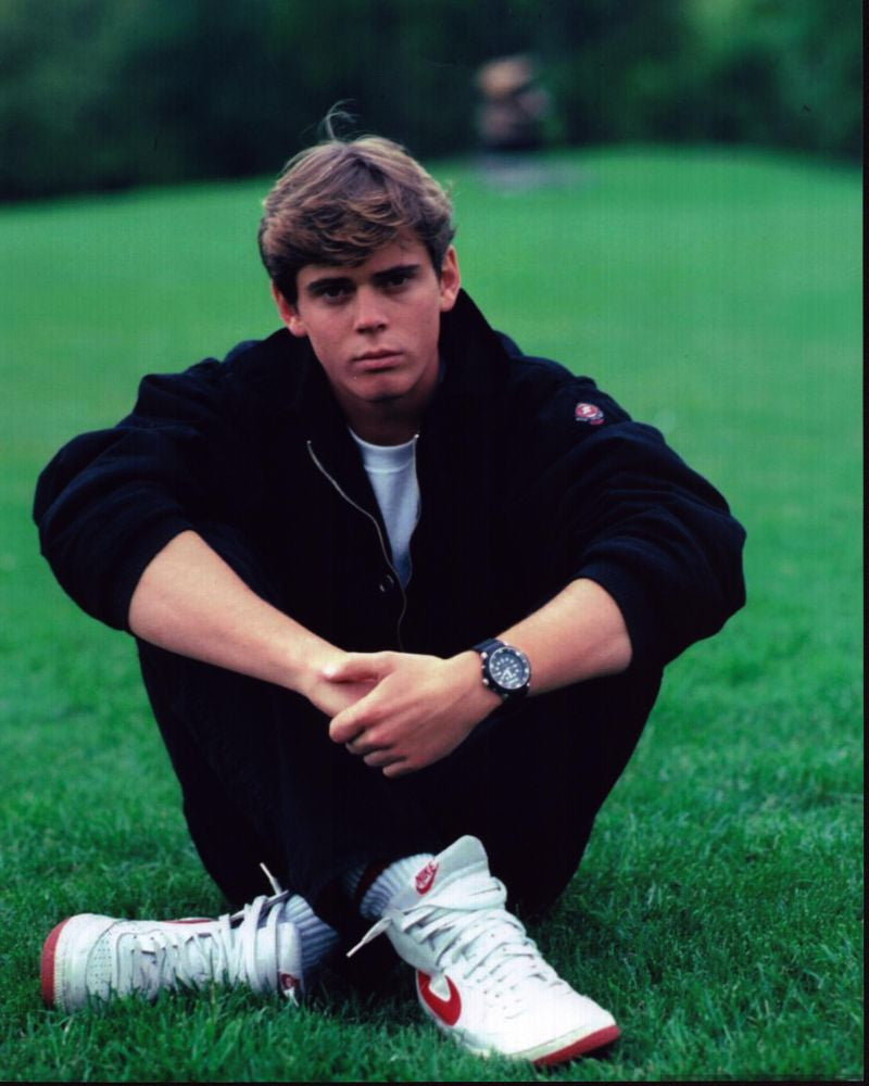 C. Thomas Howell Sitting in Grass Photo Print - Multiple Sizes