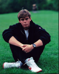C. Thomas Howell Sitting in Grass Photo Print - Multiple Sizes
