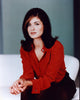 Debra Messing sitting in a red top photo print