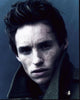 Eddie Redmayne headshot in a stylish jacket with collar up.