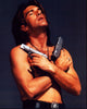 Antonio Banderas shirtless holding two guns in a scene from Desperado photo print.