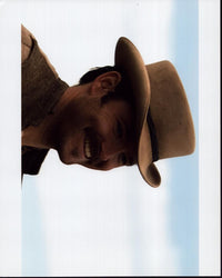 Scott Cooper smiling in vest and hat photo print.