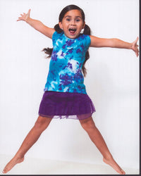 Carmina Garay Jumping In Purple Skirt Photo Print showcasing a dancer in mid-jump with a flowing purple skirt.