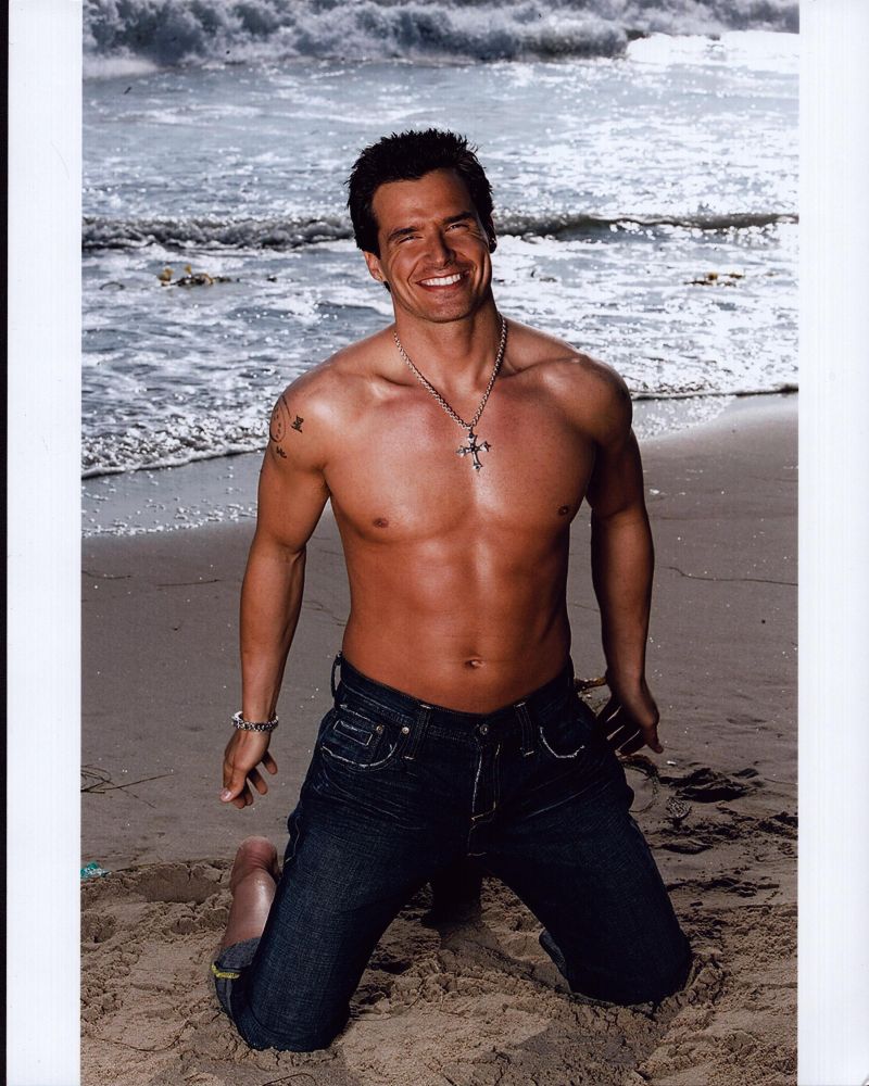 Antonio Sabato Jr. shirtless kneeling on beach photo print.