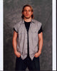 Charlie Hunnam stylish photo print in tan top with hands in pockets.