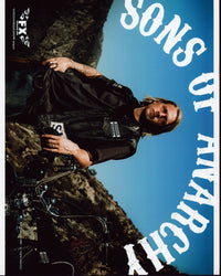 Charlie Hunnam Sons Of Anarchy Photo Print featuring Jax Teller next to a motorcycle.