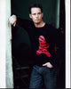 Kevin Dillon leaning against a wall in a black and red top photo print.