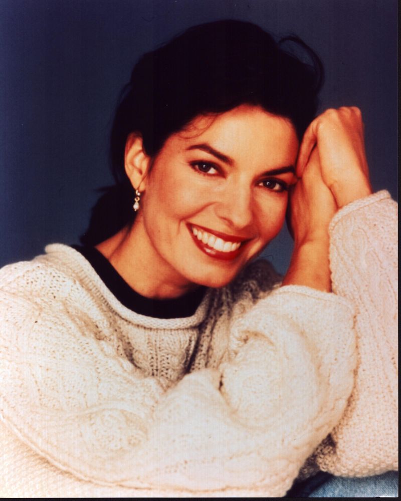 Sela Ward in tan sweater photo print showcasing elegance and style.