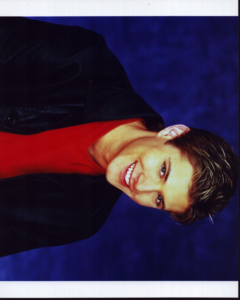 Jensen Ackles smiling in leather jacket and red shirt photo print.