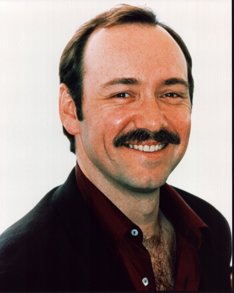 Kevin Spacey photo print featuring mustache and open red shirt.