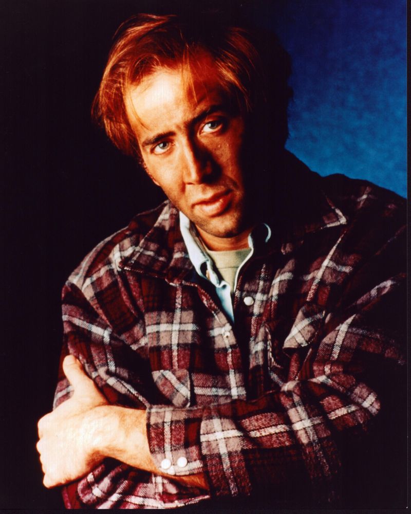 Nicolas Cage photo print arms crossed in flannel shirt.