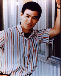 Bruce Lee leaning on wall in striped shirt photo print