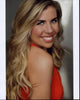 Sainty Nelsen looking over shoulder photo print in orange top.