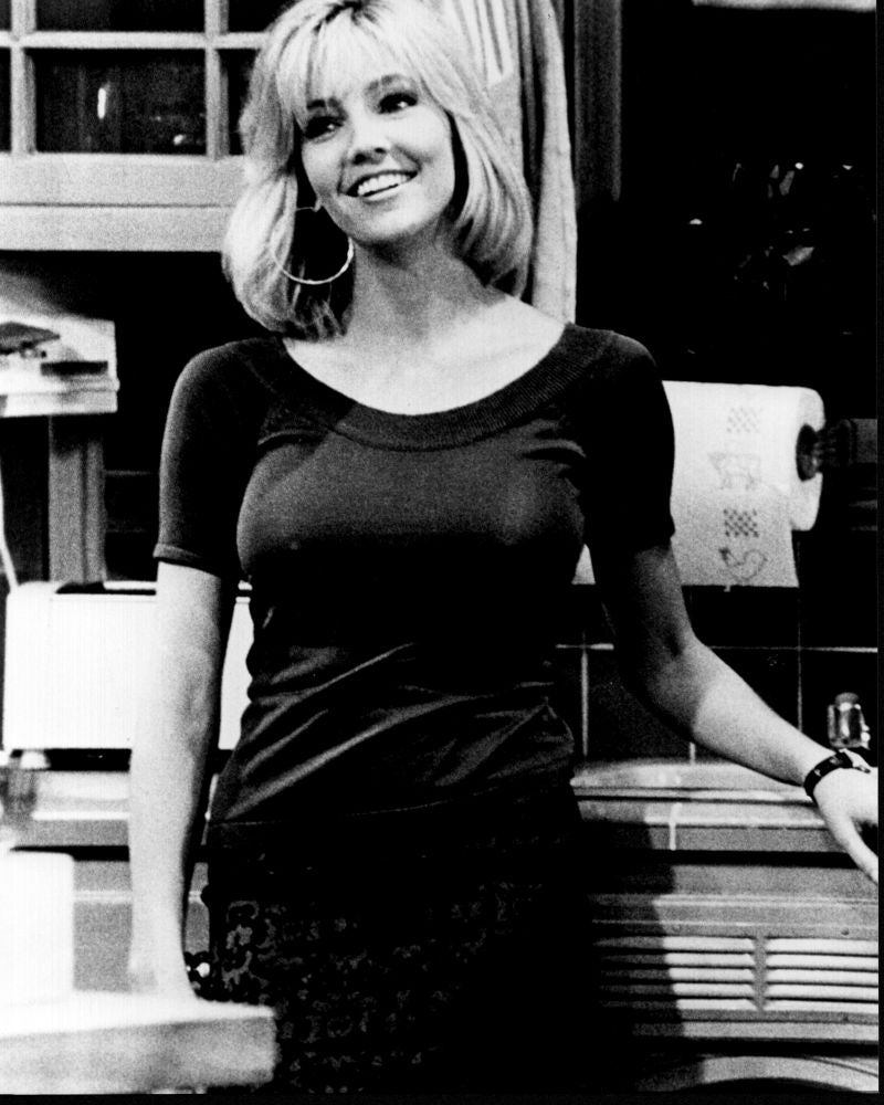 Black and white photo print of Heather Locklear standing at a counter.