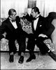 Boris Karloff and Bela Lugosi sitting on a couch in tuxedos black and white photo print.