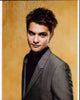 Luke Grimes photo print in gray suit with yellow background.