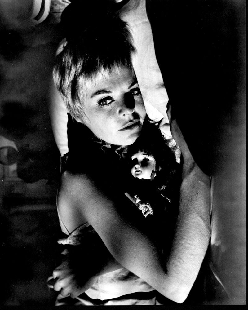 Black and white photo print of Susannah York laying with doll in The Killing of Sister George.