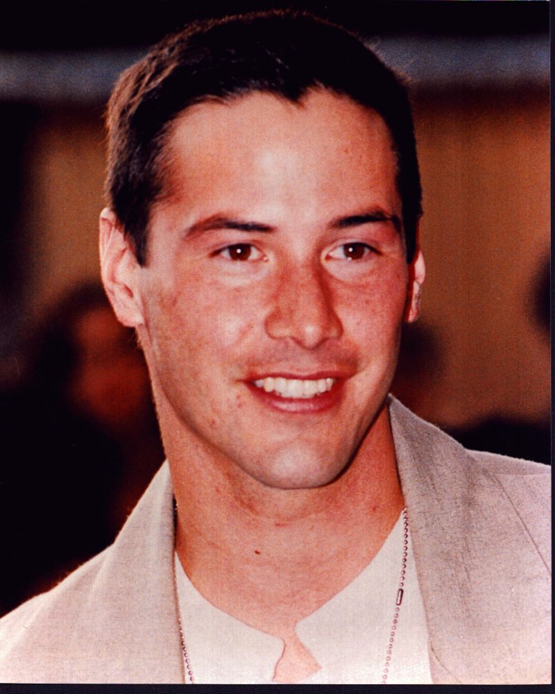 Close-up photo print of Keanu Reeves in a tan suit.
